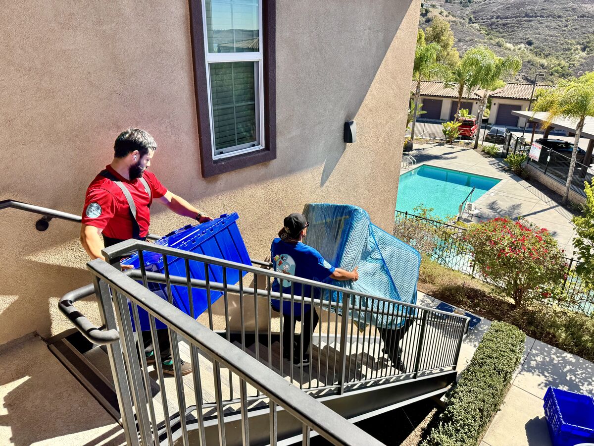 Just Move It crew carrying furniture up stairs